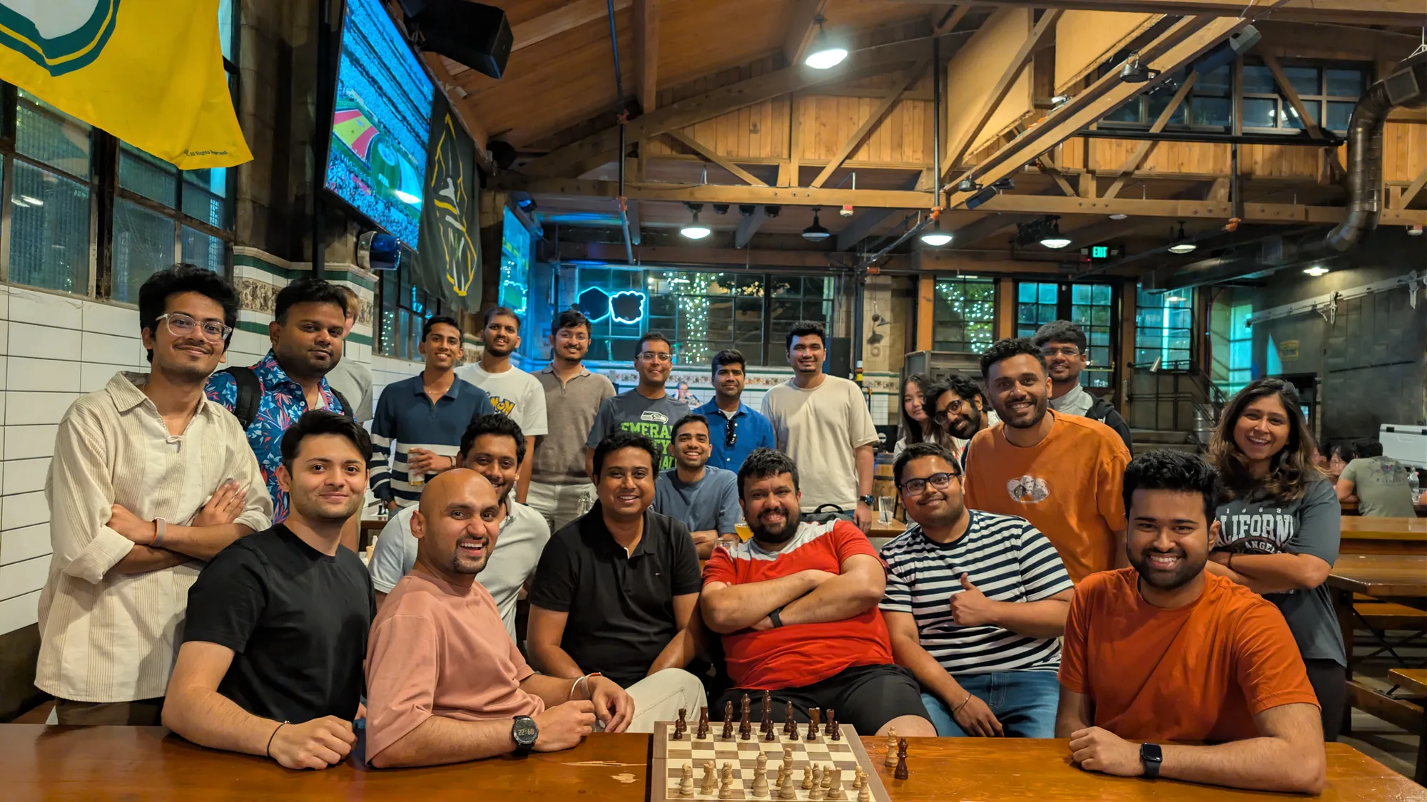 About twenty club members gathered in a wood-beamed beer hall, with a chess board set up on the table in front of them.